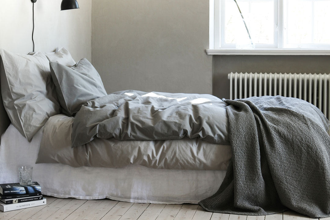 dove grey cotton throw on bed