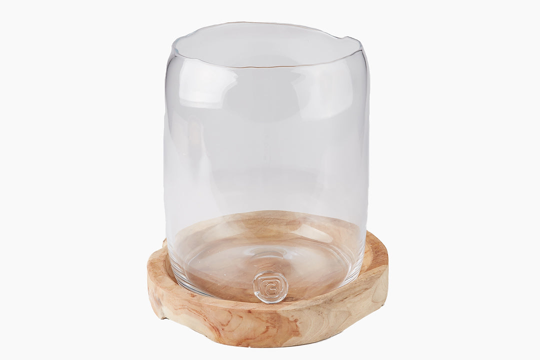 glass hurricane vase on teak dish