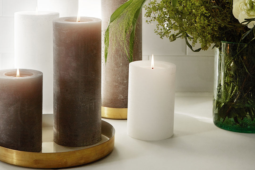 white and stone pillar candles